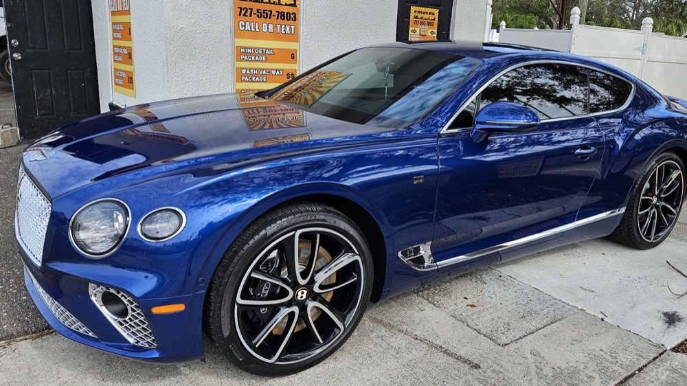 Blue Bentley Continental GT with mirror-finish detail