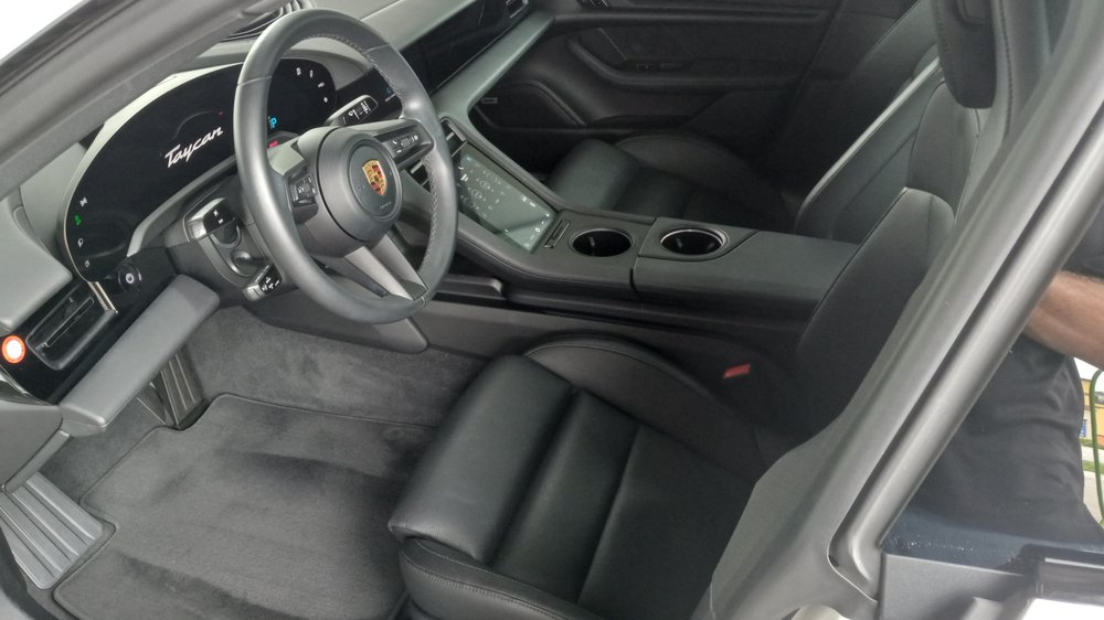 Porsche Taycan interior — clean leather seats and dashboard